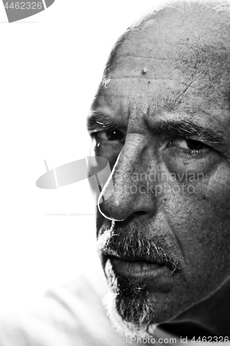 Image of Back lit three quarter portrait of serious man