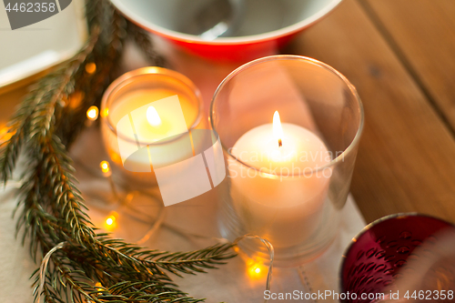 Image of candles burning on christmas table