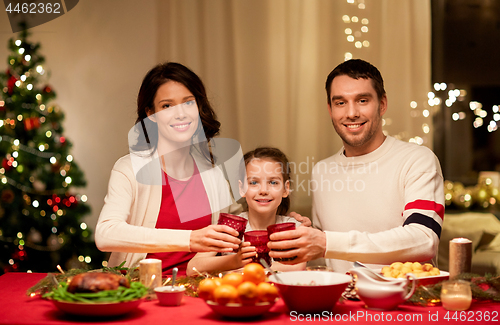 Image of happy family having christmas dinner at home