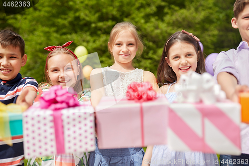 Image of happy kids with gifts on birthday party in summer