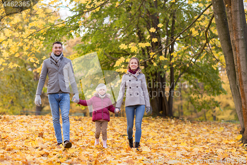 Image of happy family walking at autumn park