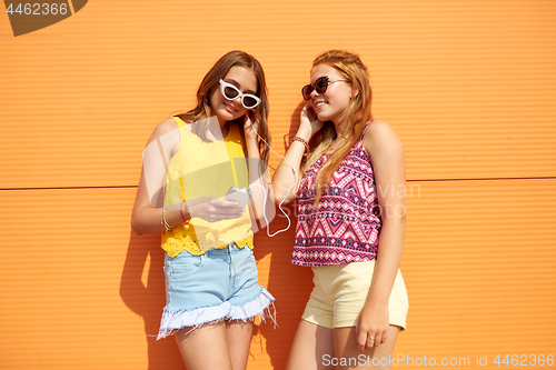 Image of teenage girls listening to music from smartphone