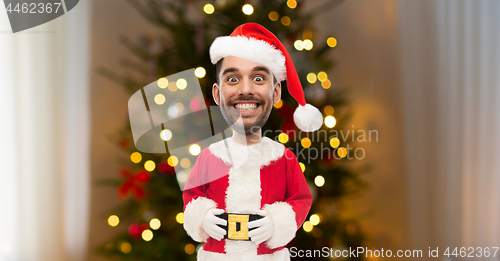 Image of santa with funny face over christmas tree