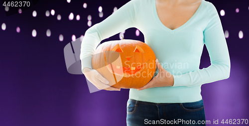 Image of close up of woman holding halloween pumpkin