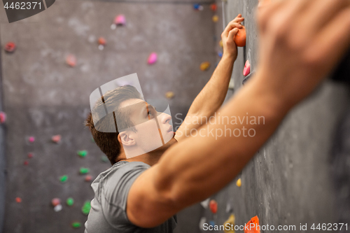 Image of young man exercising at indoor climbing gym