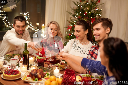 Image of friends celebrating christmas and drinking wine