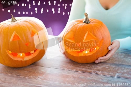 Image of close up of woman with halloween pumpkins