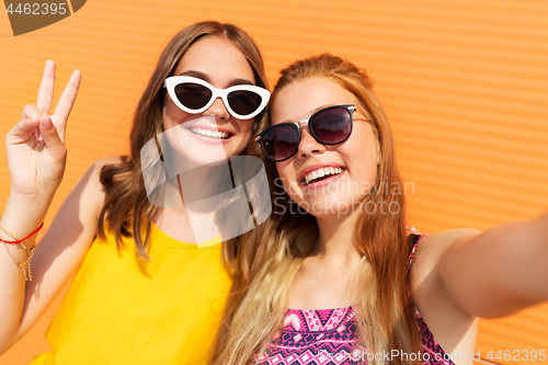 Image of teenage girls taking selfie in summer
