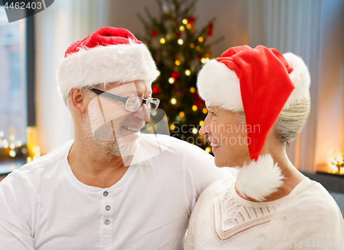 Image of happy senior couple at home on christmas