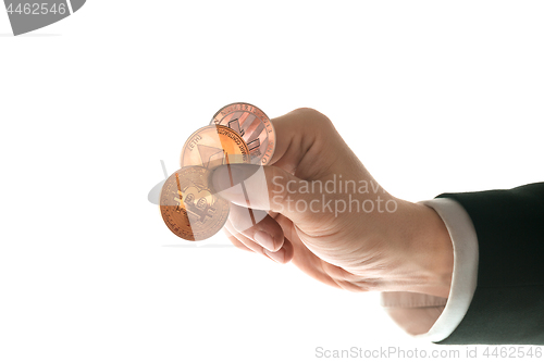 Image of Male hand with golden bitcoin on white background