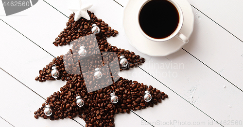 Image of Beans in shape of fir and cup of coffee