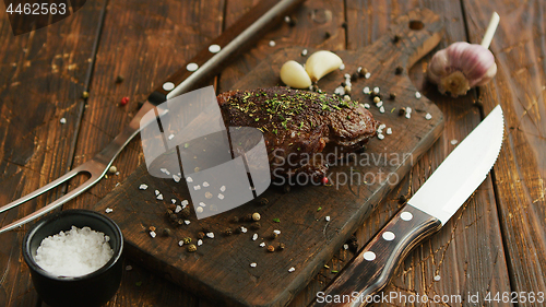 Image of Cutlery and spices near meat