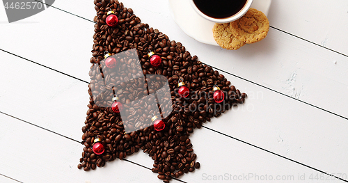 Image of Beverage and cookies near Christmas tree from coffee beans