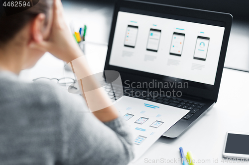 Image of stressed designer with user interface on laptop
