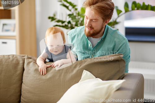 Image of happy father with little baby daughter at home