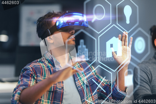 Image of man in vr headset with virtual interface at office