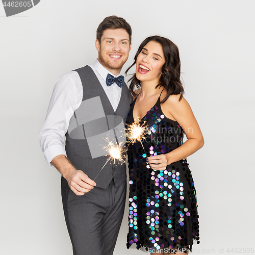 Image of happy couple with sparklers at party