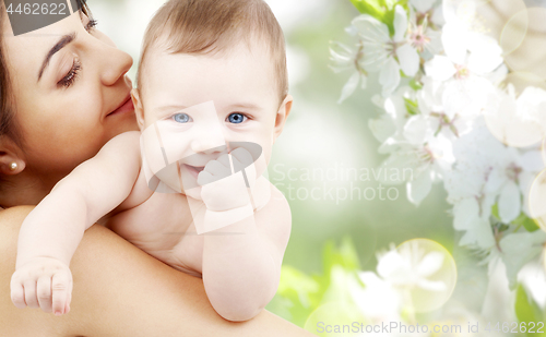 Image of close up of mother with baby over cherry blossoms