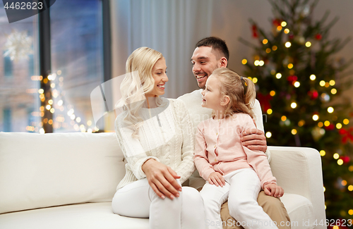 Image of happy family at home over christmas tree lights