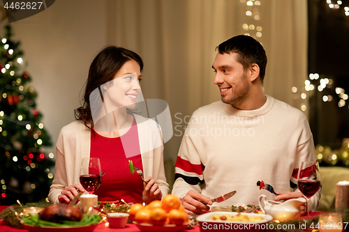 Image of happy couple eating at christmas dinner