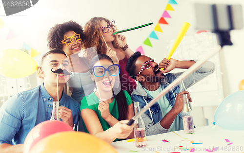 Image of happy team taking selfie at office party