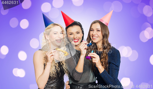 Image of happy women with party caps hugging