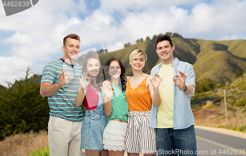 Image of friends showing ok over big sur hills and road