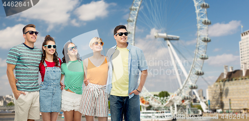 Image of friends in sunglasses over ferry wheel in london