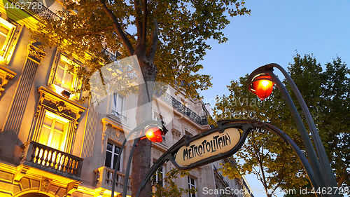 Image of Famous sign of metro station in night Paris