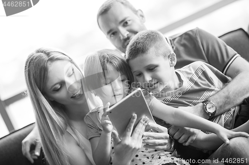 Image of happy young couple spending time with kids