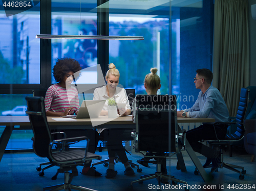 Image of Multiethnic startup business team in night office