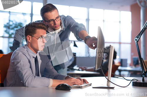 Image of Two Business People Working With computer in office