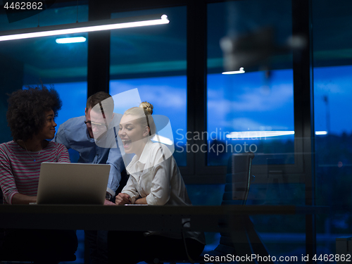 Image of Multiethnic startup business team in night office