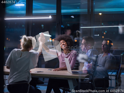 Image of Multiethnic startup business team in night office