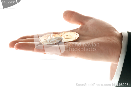 Image of Male hand with golden bitcoin on white background