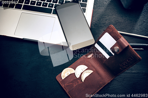 Image of The golden bitcoin, phone, keyboard