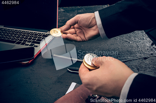 Image of The golden bitcoin in mail hands