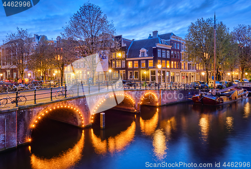 Image of Amterdam canal, bridge and medieval houses in the evening