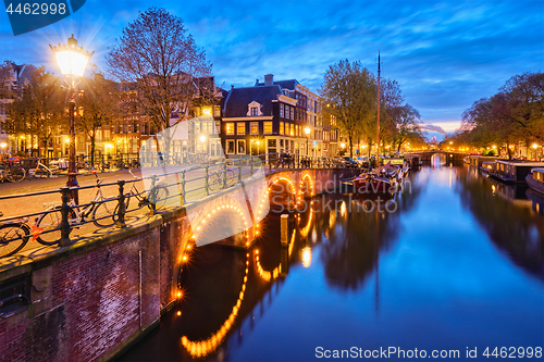 Image of Amterdam canal, bridge and medieval houses in the evening