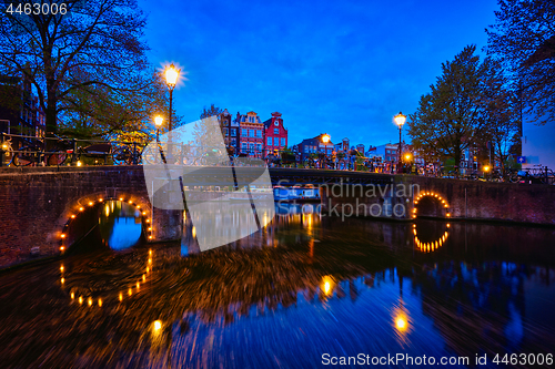 Image of Amterdam canal, bridge and medieval houses in the evening