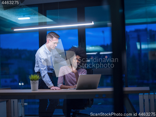 Image of Multiethnic startup business team in night office