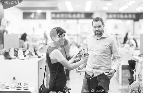 Image of couple chooses shoes At Shoe Store