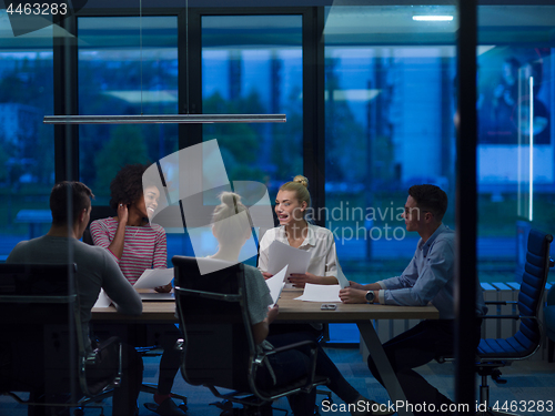 Image of Multiethnic startup business team in night office