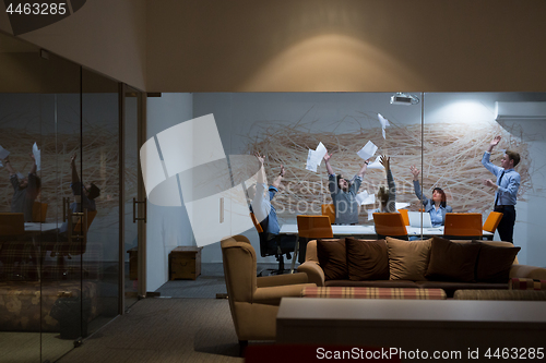 Image of Group of young business people throwing documents