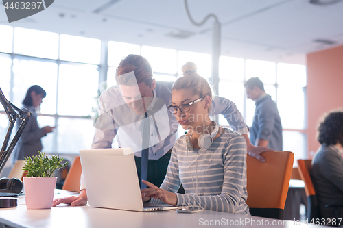 Image of Two Business People Working With laptop in office