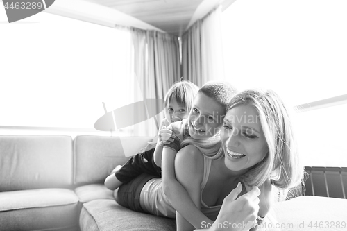 Image of young mother spending time with kids on the floor