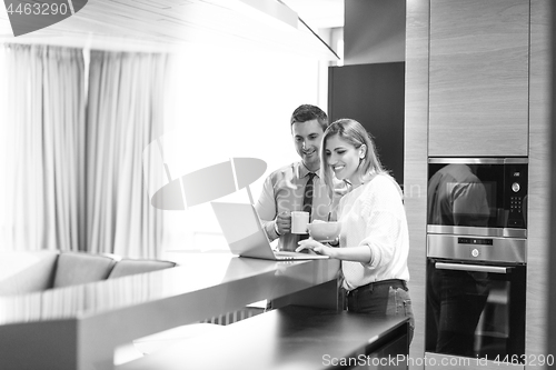 Image of A young couple is preparing for a job and using a laptop