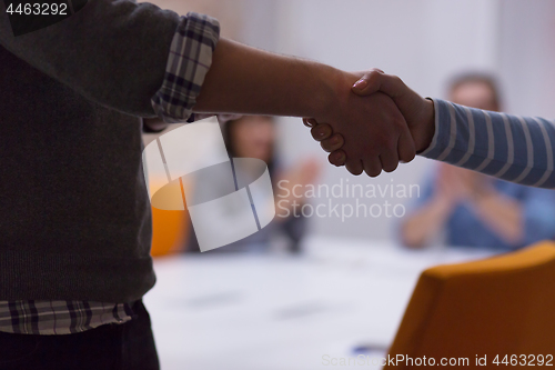 Image of cloasing the deal in modern office interior