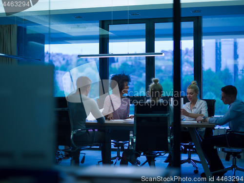 Image of multiethnic Group of young business people throwing documents