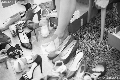 Image of woman sitting in shoe store